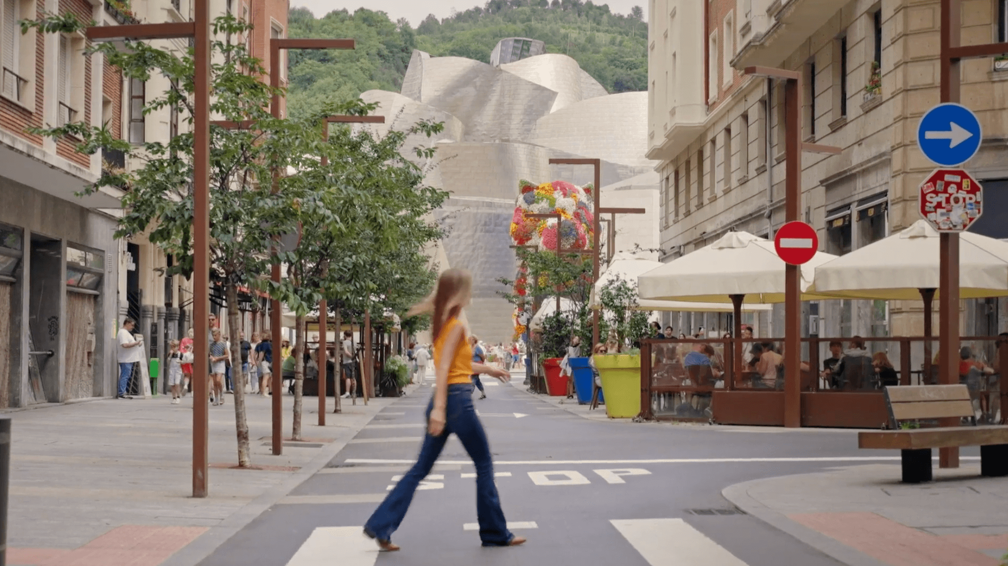 A woman crosses the street in Rioja country